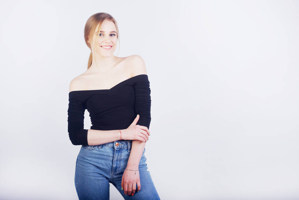 Blonde student smiling over white background. Empty space for text or product. - Foto, afbeelding