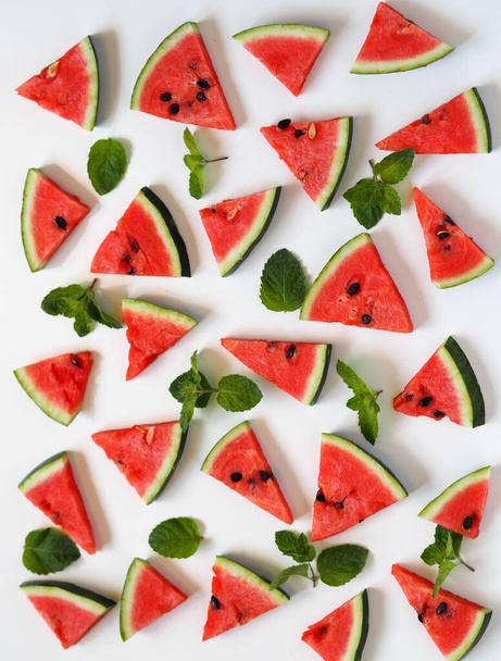 Food background with watermelon slices and mint leaves. Healthy natural food rich in vitamins. Watermelon is a popular organic farming product. - Photo, Image