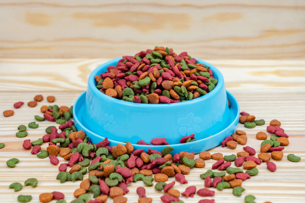 Pet food in bowl on wooden background - Zdjęcie, obraz