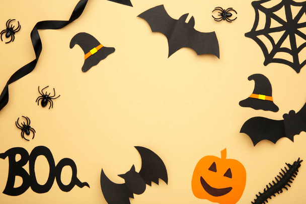 Halloween composition with spiders and bats on biege background. Top view - Photo, Image