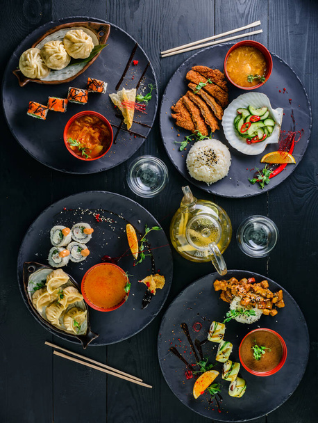 traditional Japanese food dishes served on the table. Set of sushi, rolls, Japanese food served table top view, flat lay - Photo, Image