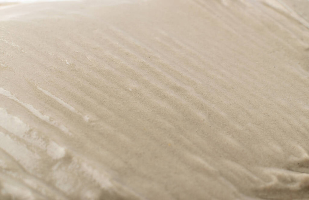 Light beige wet sand texture pattern, damp sandy beach textured background top view with copy space - Fotografie, Obrázek