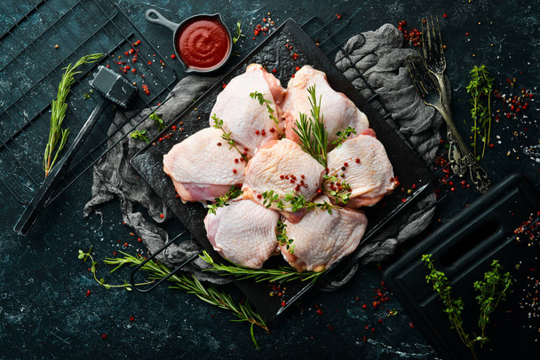 Raw chicken thighs with ingredients and spices on kitchen background. Meat. Top view. Rustic style. - Fotografie, Obrázek