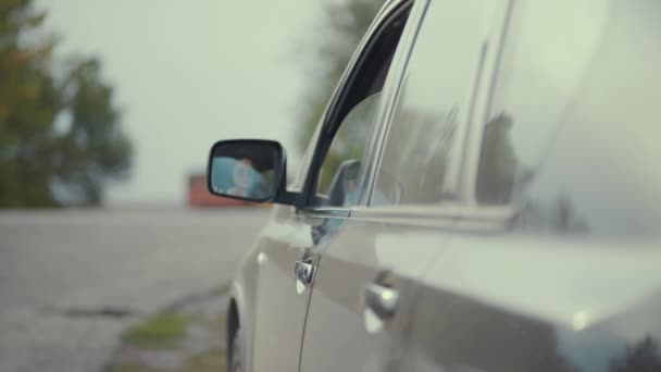 Chauffeur jetant bouteille en plastique de la fenêtre de la voiture sur la route. - Séquence, vidéo