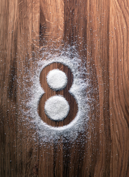 Grains of sugar in shape of eight. - Photo, Image