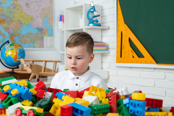 Child playing with colorful toys at kindergarten. Early development. Junior School. Preschool pupil. Cute little boy studying. - Fotografie, Obrázek