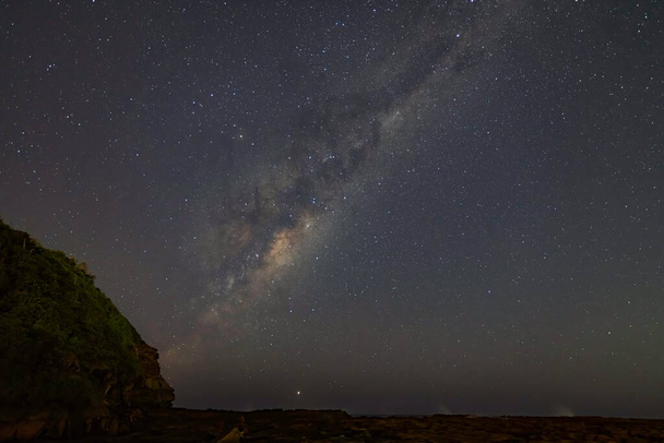 Stars and the Milky Way Night Sky with Rock Platform and Headland taken from North Avoca Beach on the Central Coast of NSW, Australia. - Foto, imagen