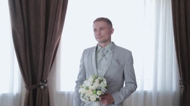Handsome man with wedding bouquet in hands. - Footage, Video