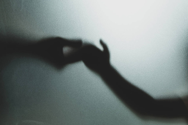 Concept fantôme ombre de la main derrière la main floue en verre mat et le corps focu doux - Photo, image
