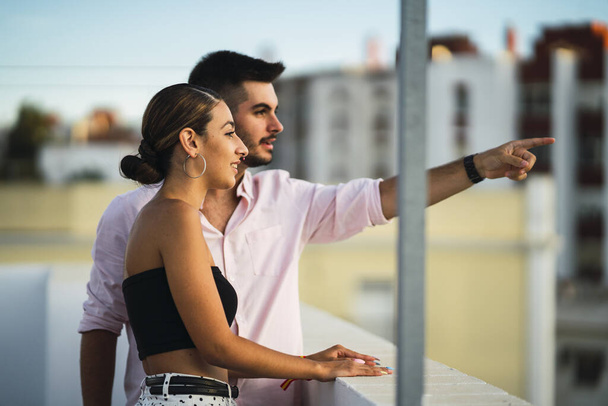 A happy couple standing in the balcony and having some romantic time together - Photo, Image