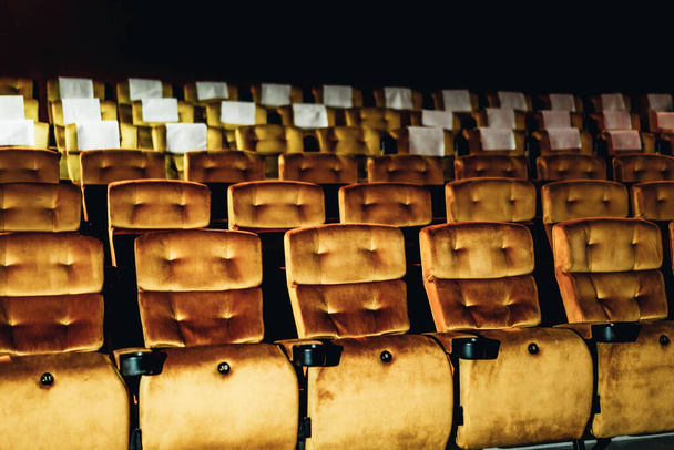 A row of yellow seat with popcorn on chair in the movie theater - Foto, Imagen