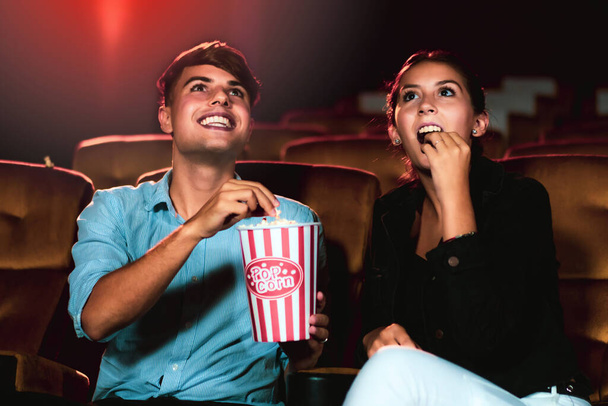 Man and woman watching movie in the movie theater cinema. Group recreation activity and entertainment concept. - Foto, Imagen