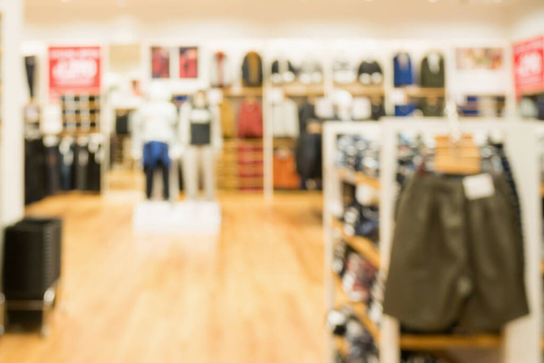 Tienda de ropa de moda borrosa abstracta en el fondo del centro comercial moderno - Foto, imagen