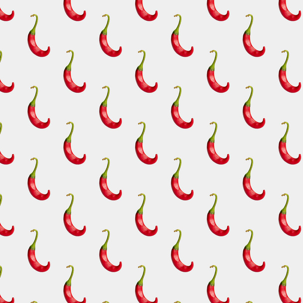 Red hot chili pepper isolated on a light background, seamless background  - Photo, Image