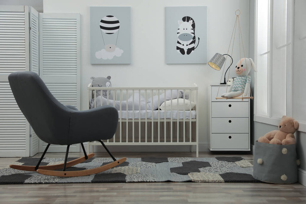 Stylish baby room interior with crib and rocking chair - Fotoğraf, Görsel
