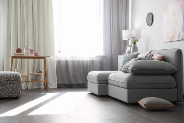 Elegant living room with comfortable sofa near window. Interior design - Φωτογραφία, εικόνα
