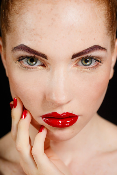 Close-up portrait of sexy european young woman model with glamour make-up and red bright manicure. christmas makeup, bloody red lips with gloss - Fotografie, Obrázek