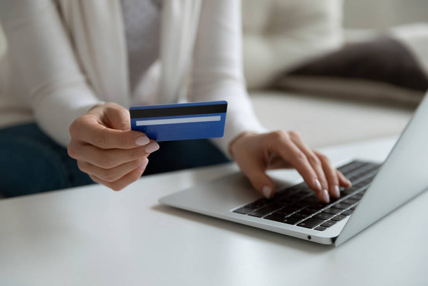 Female client entering payment information confirming internet purchase. - Zdjęcie, obraz