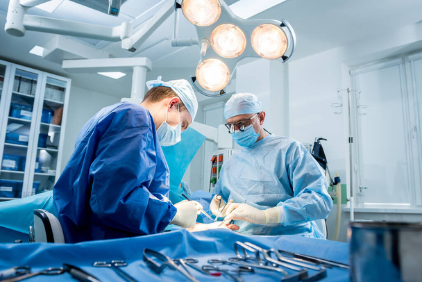 Surgeons in the operating room trying to save the patients hand. - Valokuva, kuva