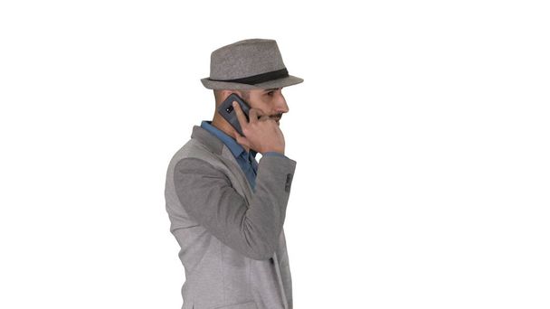 Arabic man in casual walking and making a phone call on white background. - Foto, Imagen