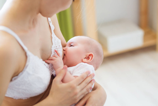 Mother breast feeding her little boy. Mom nursing and feeding baby. Close-up portrait of infant - Photo, Image