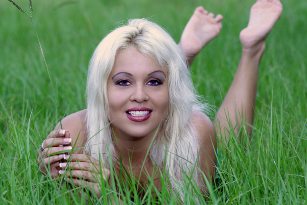 Sexy Blonde Lying in a Grassy Field (4) - Photo, Image