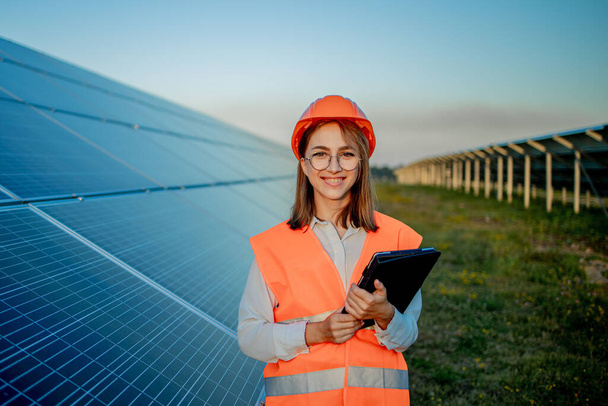 Inspector Engineer Woman Holding Digital Tablet Working in Solar Panels Power Farm, Photovoltaic Cell Park, Green Energy Concept. - Photo, image