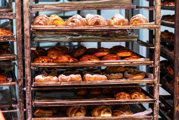 Shelves with pastries. Sweet croissants and buns. - Photo, Image