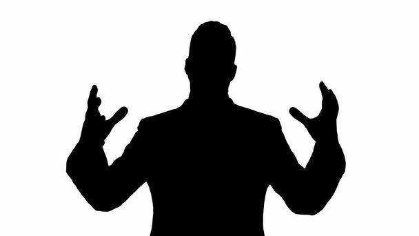 Silhouette Man in formal clothes speaking to camera doing hand gestures in a very expressive and positive way. - Foto, Imagem
