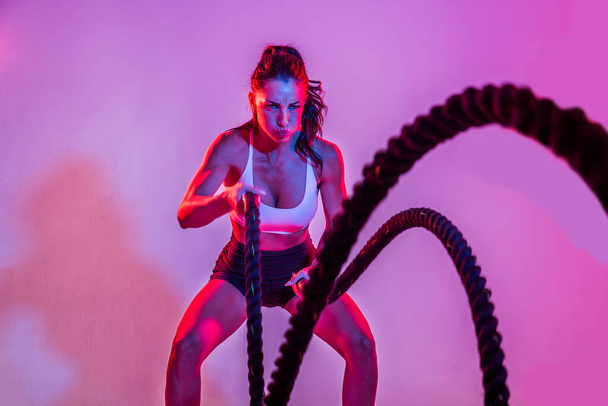 Athletic woman with fitness sportswear traning - Beautiful girl doing fitness in a studio - Fotografie, Obrázek