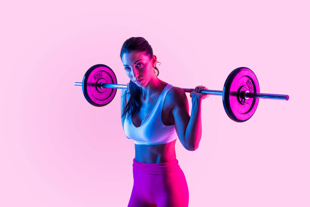 Athletic woman with fitness sportswear traning - Beautiful girl doing fitness in a studio - Φωτογραφία, εικόνα