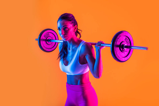Athletic woman with fitness sportswear traning - Beautiful girl doing fitness in a studio - Fotografie, Obrázek