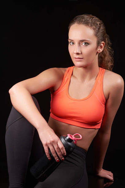 pretty caucasian fitness woman on black isolated background - Photo, image