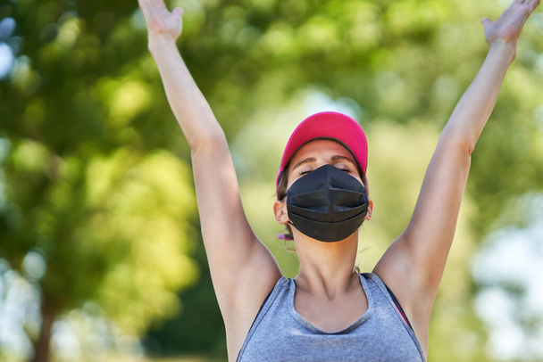 Female jogger running in mask in the countryside - Foto, Imagem