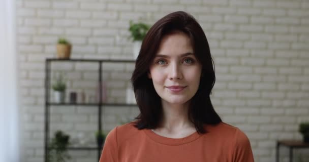Headshot portrait young woman standing indoors smiling posing for camera - Metraje, vídeo