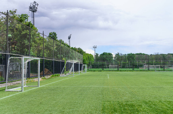 Football goals are on pitch for soccer training. Green sod covering. Copy space - Zdjęcie, obraz