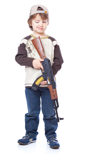 Portrait of little boy with automatic weapon (Kalashnikov) - Photo, Image
