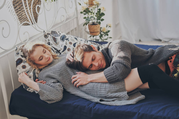 attractive man and woman in the bedroom together cuddling cute - Fotografie, Obrázek