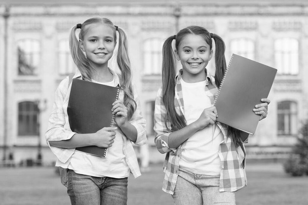 Help your kids catch up or get ahead without summer school. School club. Modern education. Private schooling. Teens with backpacks. Stylish smiling schoolgirls. Girls school building background - Foto, Imagem