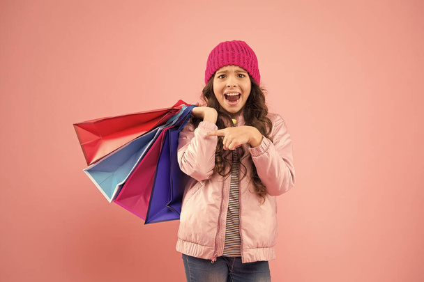Winter shopping. Buyer consumer concept. Christmas sale. Kid fashion. Holiday purchase saving. Home shopping. Small girl with shopping bags. Sales and discounts. Happy child. Little girl with gifts - Foto, Imagen