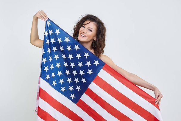 Attractive girl with American flag. photo session in the studio on a white background. - Fotoğraf, Görsel