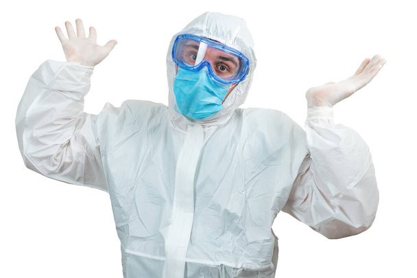 Překvapený mužský lékař s rukama nahoru v bílém ochranném obleku a masce izolované na bílém pozadí - Fotografie, Obrázek