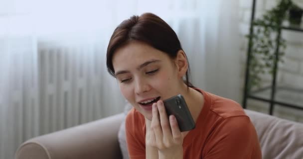 Female having pleasant conversation on smartphone use speakerphone - Кадры, видео