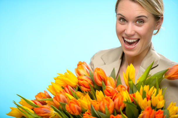 Cheerful woman with colorful spring tulips - Фото, зображення