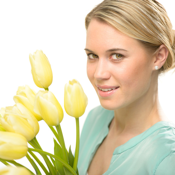 Blond woman with yellow tulips spring flowers - Zdjęcie, obraz