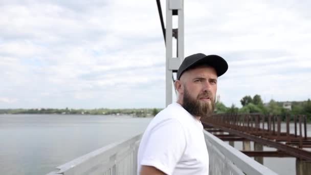 A young guy walks across the bridge - Кадри, відео