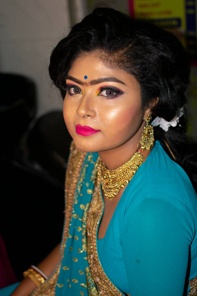 an indian teenage girl happy with indian ethnic wear and ornaments in a marriage reception party - Photo, Image