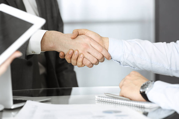 Unknown diverse business people are shaking hands finishing contract signing, close-up. Business and handshake concept - Φωτογραφία, εικόνα