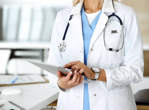Unknown woman-doctor using tablet computer, close-up. Medicine concept - Photo, image