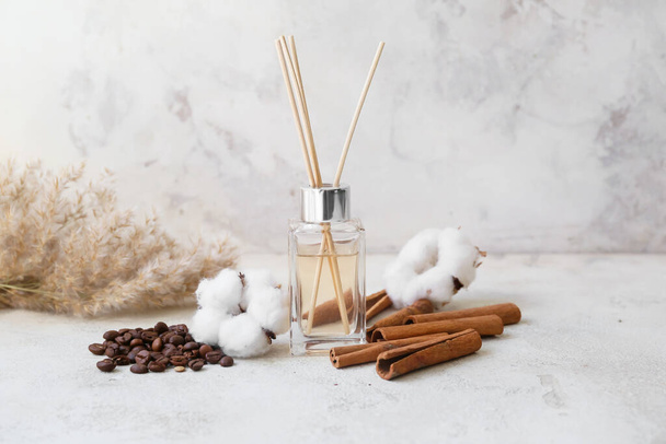 Reed diffuser, cotton, coffee beans and cinnamon on table - Photo, Image